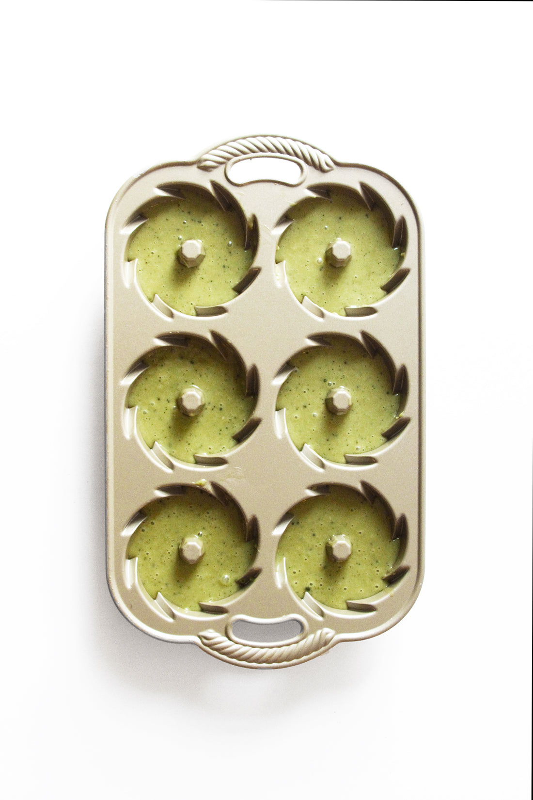 Image from above of Miss Jones Baking Co Matcha Tea Cakes batter in six cake molds