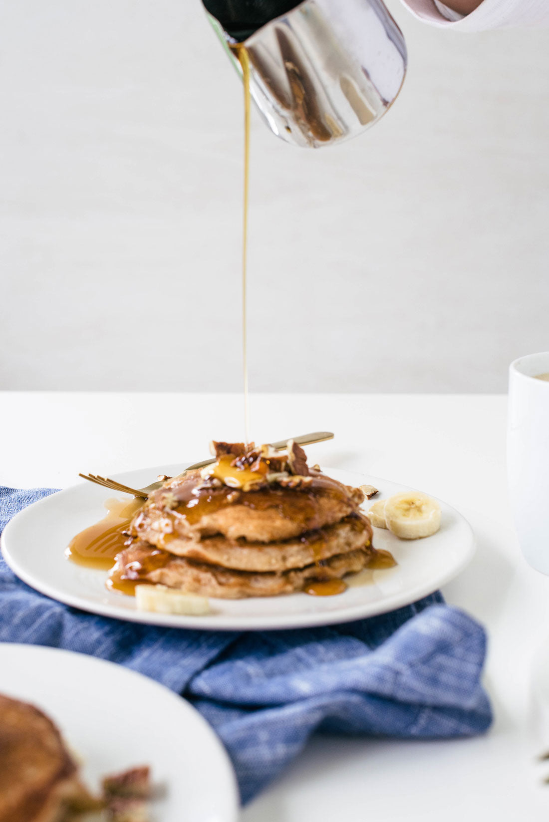 Image of side of syrup being poured on top of Miss Jones Baking Co Hummingbird Cake Batter Pancakes