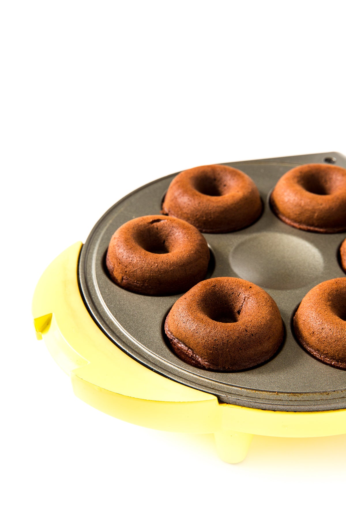 Close up image of Miss Jones Baking Co Guinness Glazed Chocolate Donuts in a yellow donut maker mold