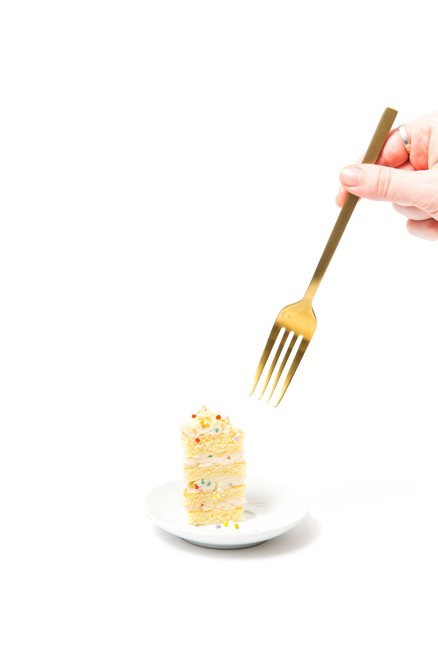 Image of side of a piece of Miss Jones Baking Co Confetti Pop Mini Cakes on a plate with a fork