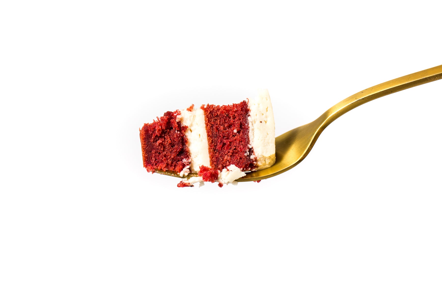 Image of a fork holding a bite of Miss Jones Baking Co Beet Red Velvet Layer Cake