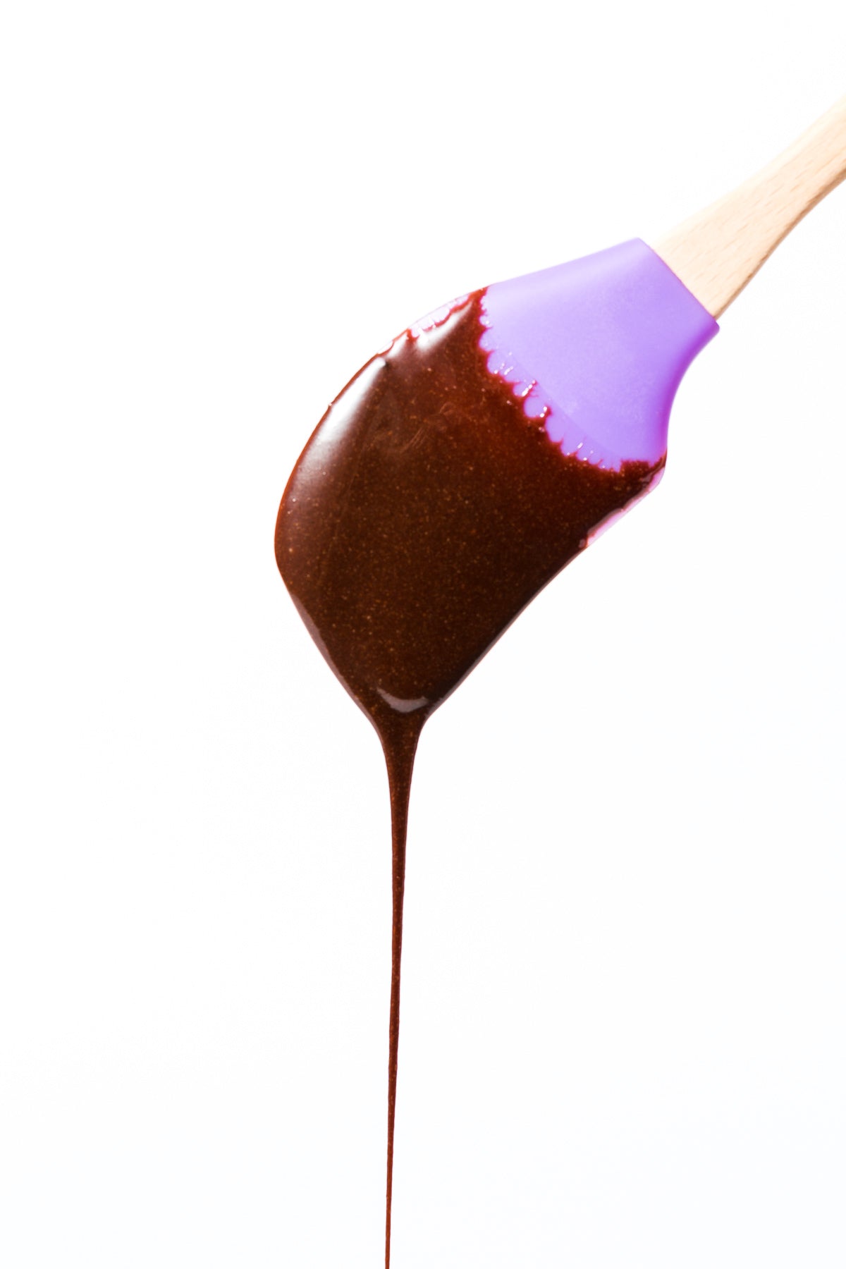 Image of brownie batter dripping off purple spatula for Miss Jones Baking Co Brownie Batter Bark recipe