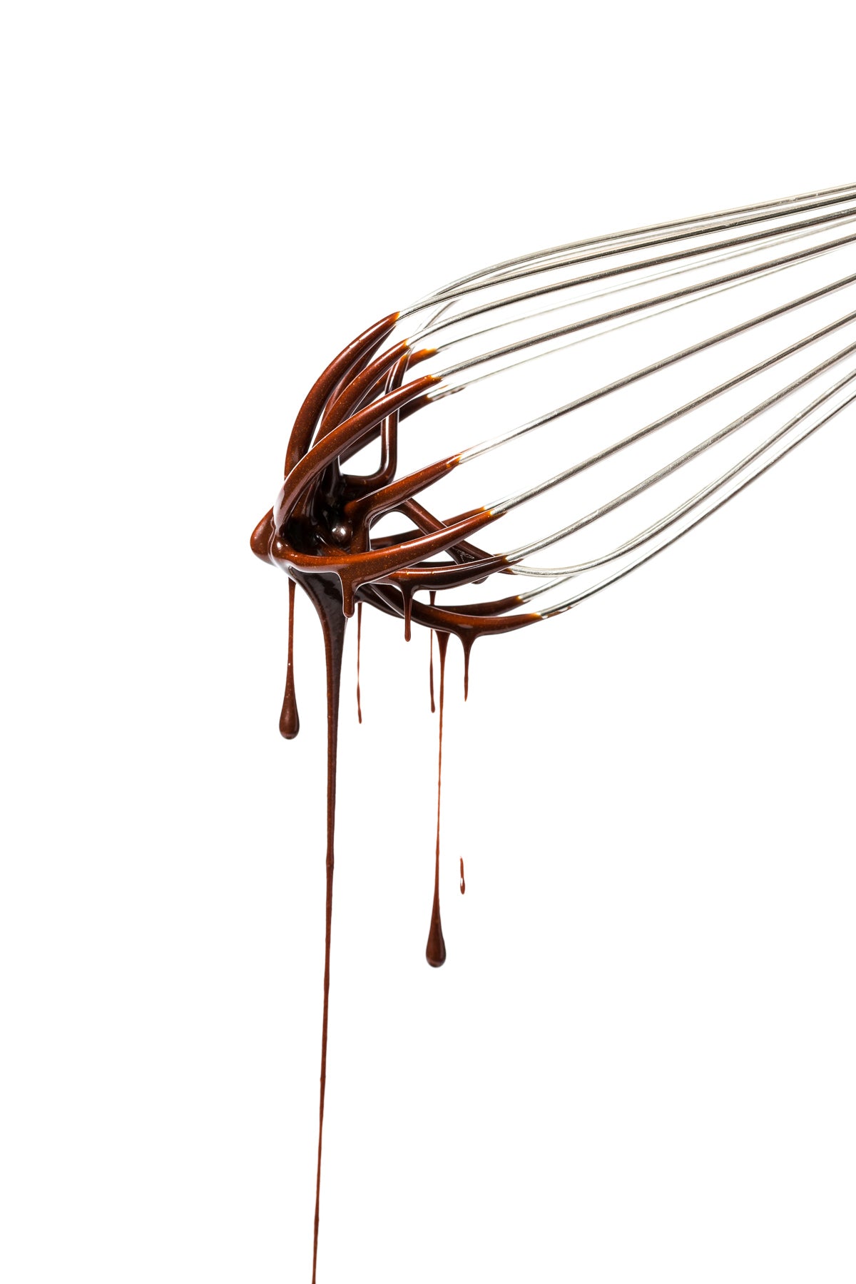 Close up image of side of spatula with melted chocolate dripping