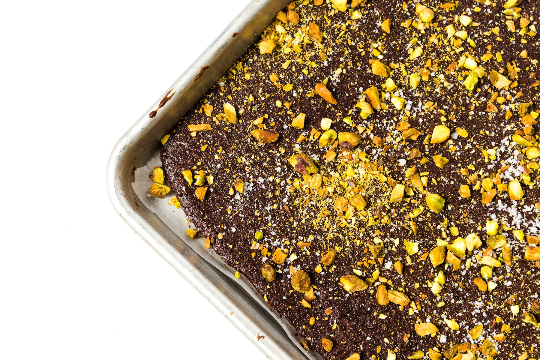 Close up image of pistachio and dark chocolate toppings on Miss Jones Baking Co Brownie Batter Bark