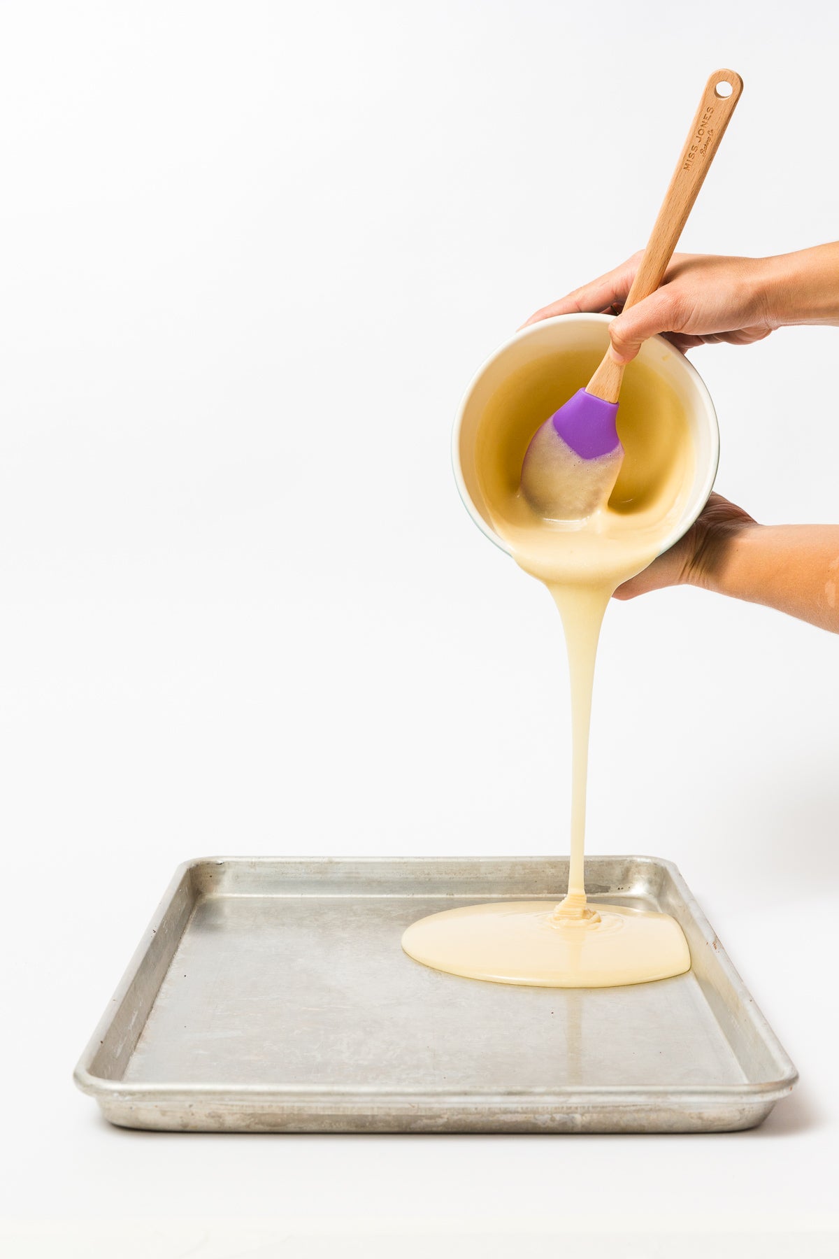 Image of Miss Jones Baking Co Confetti Pop Mini Cakes cake mix being poured onto baking sheet