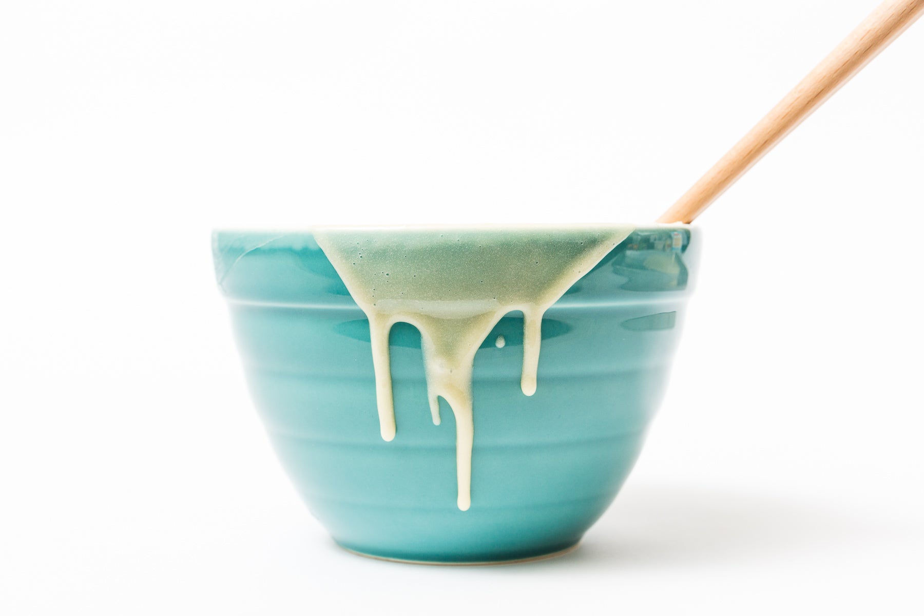 Image of side of Miss Jones Baking Co Confetti Pop Mini Cakes cake mix dripping down side of blue mixing bowl.
