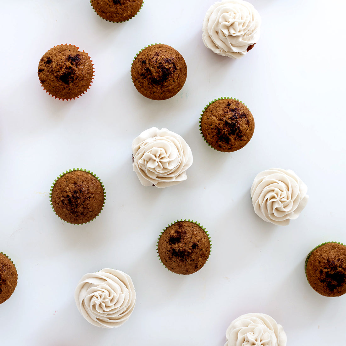 Image from above of some frosted and some unfrosted Miss Jones Baking Co Pumpkin Spice Latte (PSL) Cupcakes