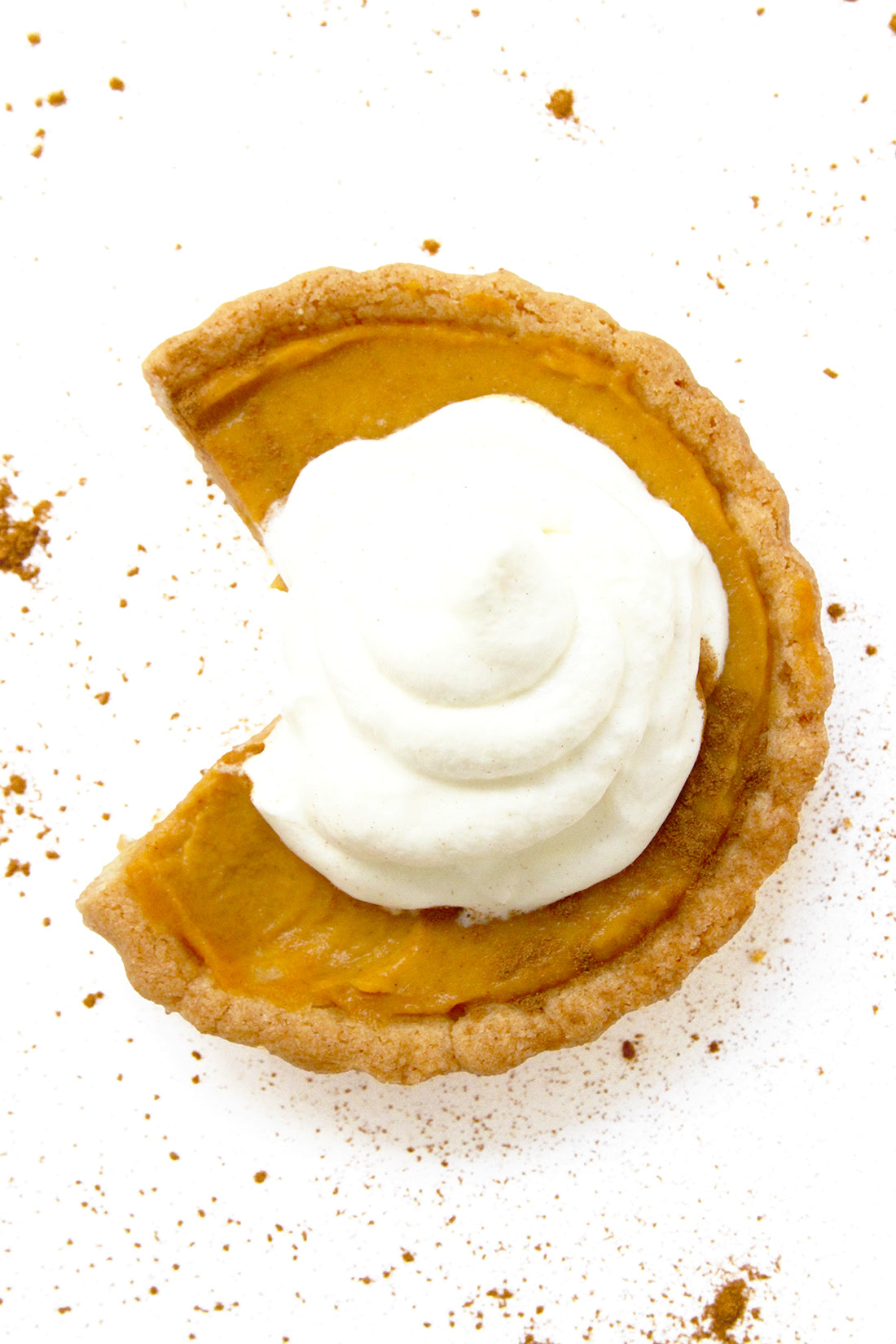 Image of the top of a Miss Jones Baking Co Perfect Pumpkin Tartlet with a slice taken out of it