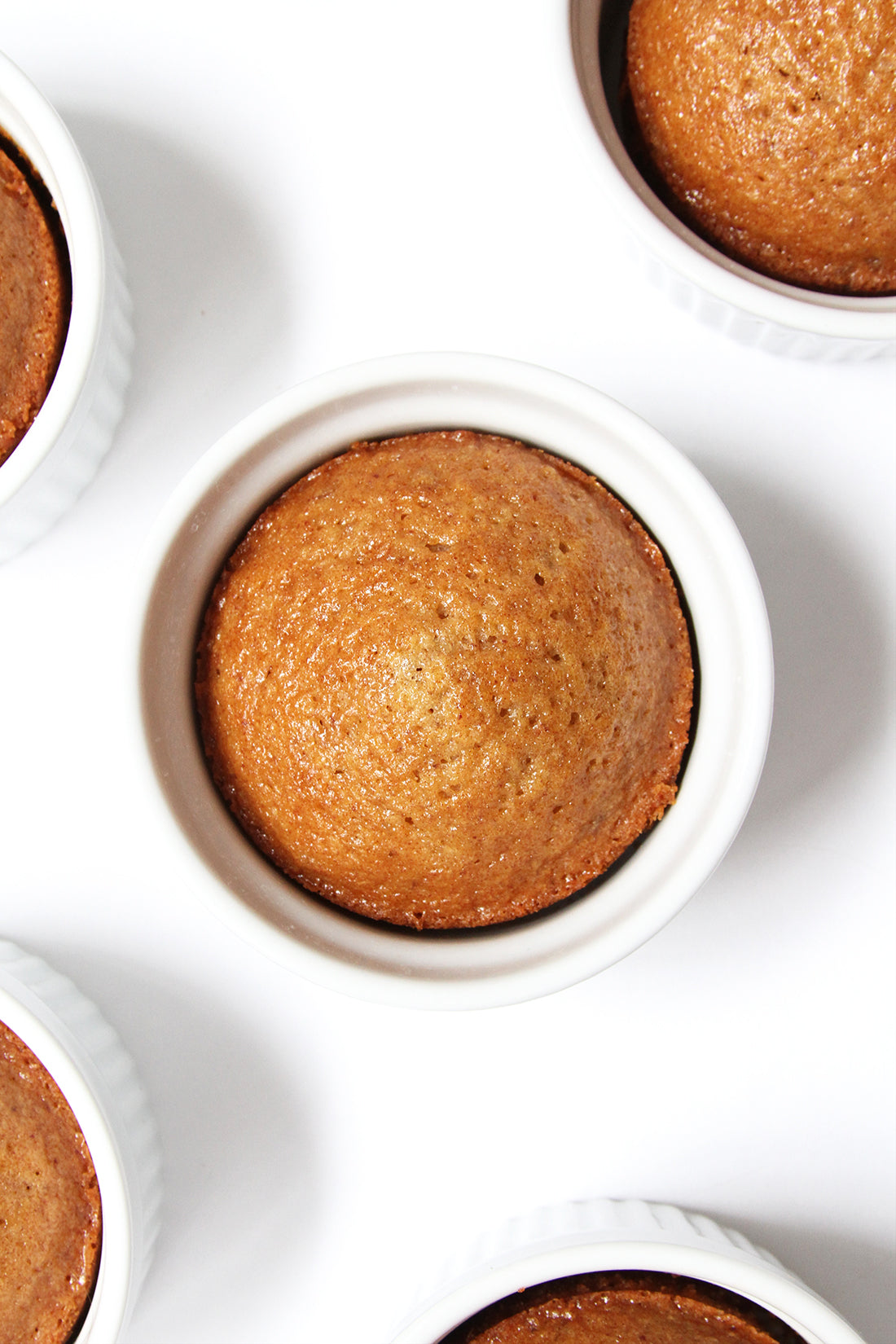 Image from above of five Miss Jones Baking Co Sticky Toffee Cakes in ramekins