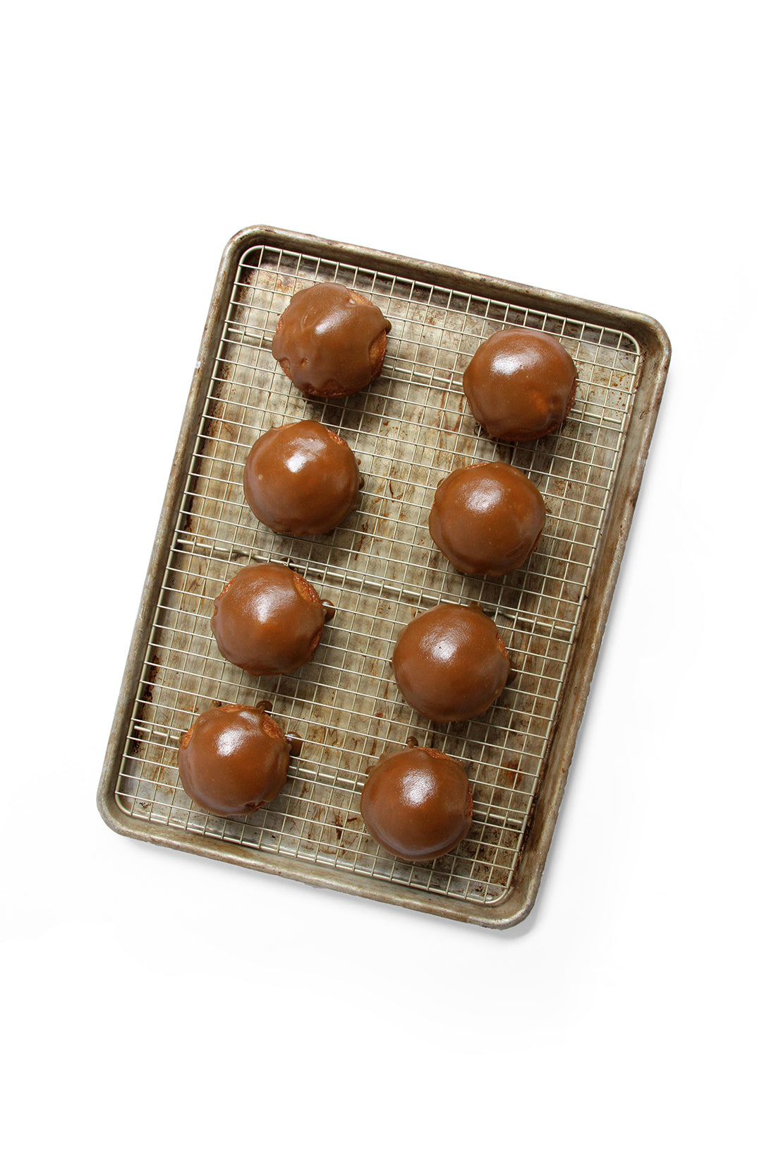 Image from above of eight Miss Jones Baking Co Sticky Toffee Cakes on a baking rack