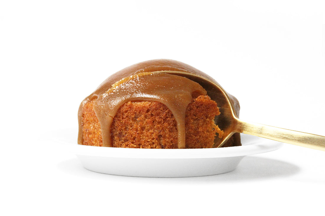 Image from the side of a spoon taking a bite of a Miss Jones Baking Co Sticky Toffee Cake