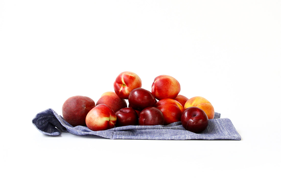 Image from the side of a towel covered in stone fruit for Miss Jones Baking Co Stone Fruit Shortcake Recipe