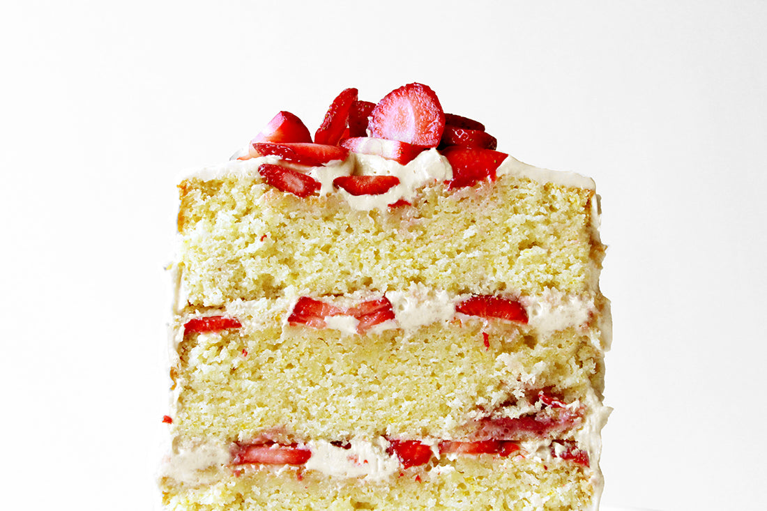 Image of side of Miss Jones Baking Co California Strawberry Cake cut in half