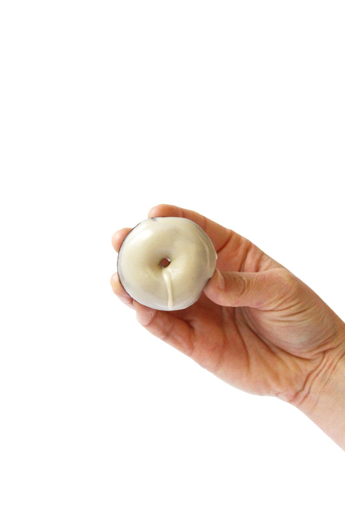 Image of a hand holding up a Miss Jones Baking Co Thin Mint Donut