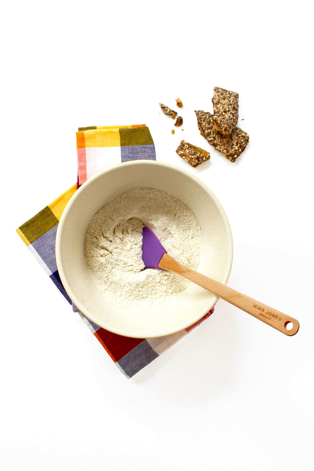 Image from above of Miss Jones Vanilla Cake mix in a mixing bowl next to toffee slices for Miss Jones Baking Co Sarah's Toffeedoodles