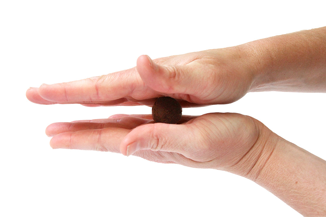 Side image of one of Miss Jones Baking Co Whiskey Wonderland Truffles being rolled into a ball