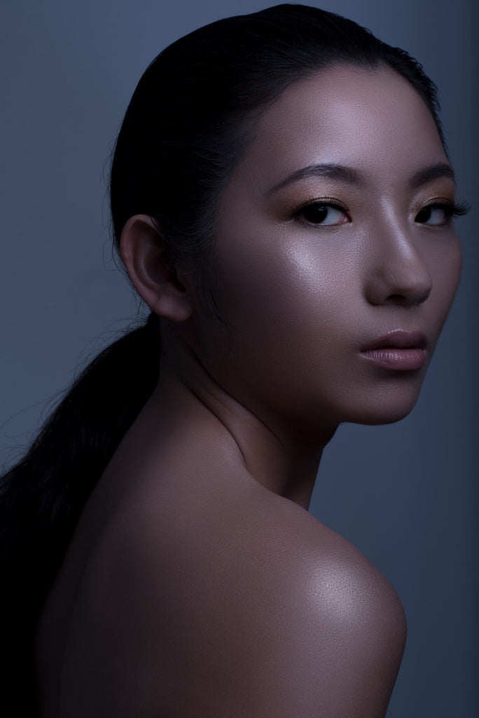 A close portrait shot of a woman with silky smooth skin.