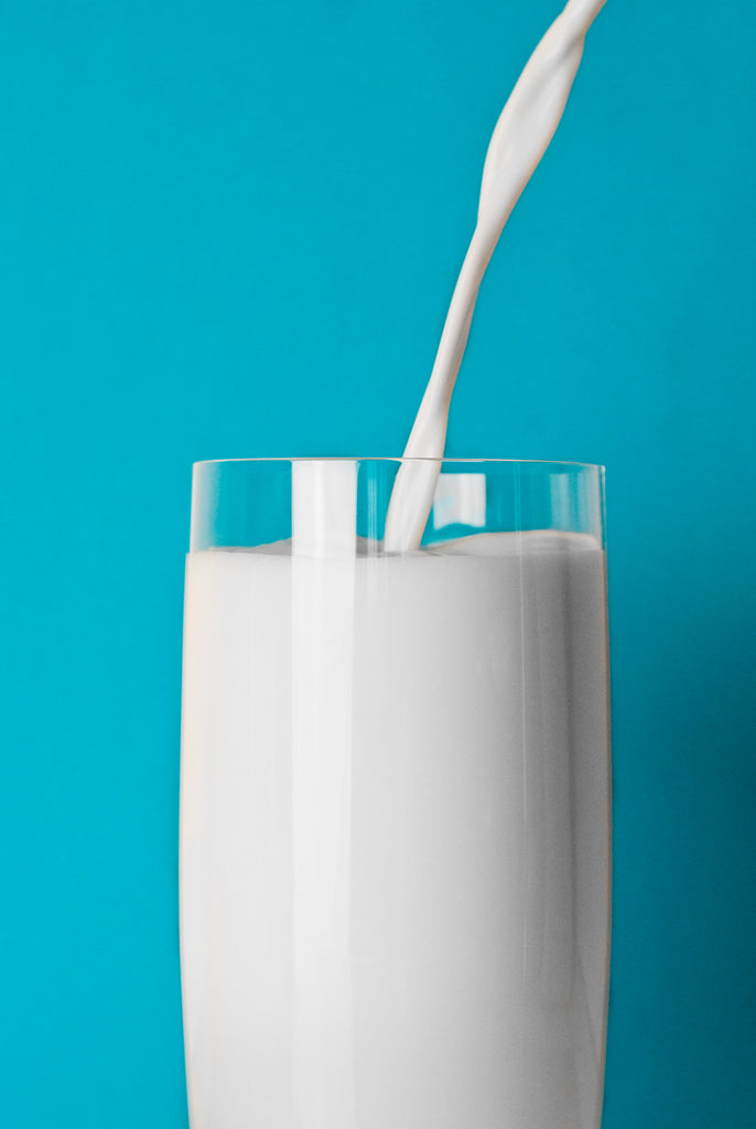 Milk is being poured in a glass.
