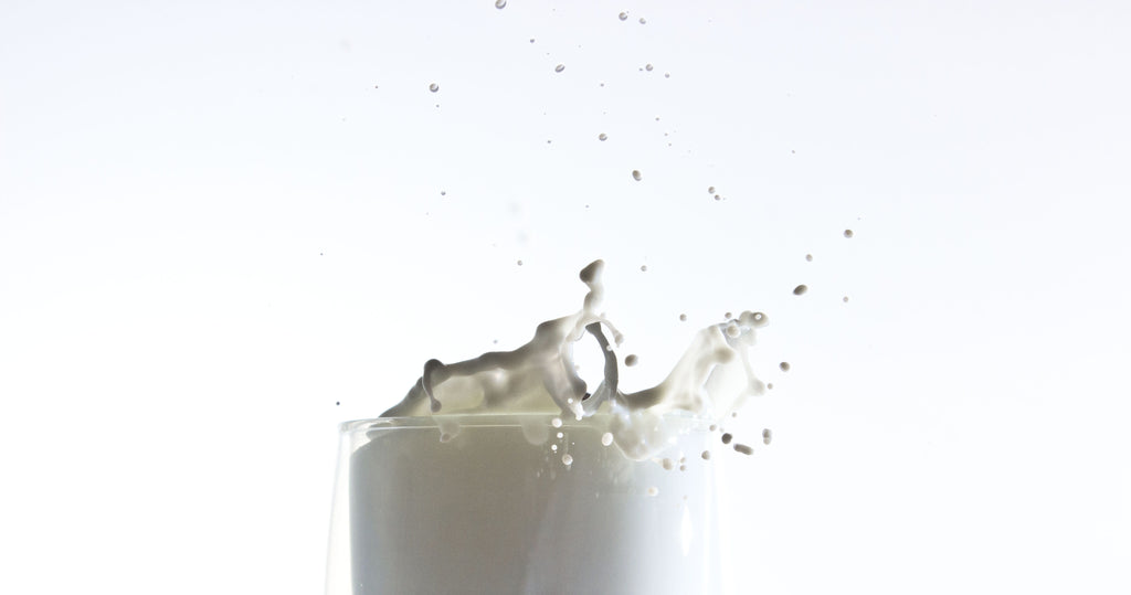 A drop of donkey milk splashing from the glass.