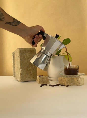 coffee being poured plant in background