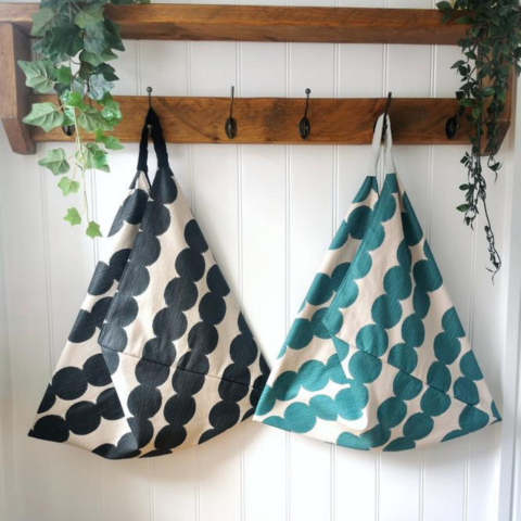 Two Kaleidoscope Textiles Origami Bags in Bobbin Shaped Pattern Print in Teal Green or Ebony and Oatmeal Beige Background and Sturdy Black or Pale Mint Green Canvas Handle