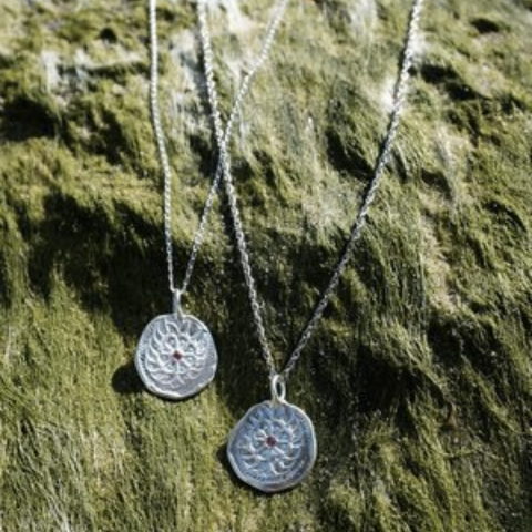 Sun Baby Silver Embossed Lucky Molten Ruby Coin Necklace on Log