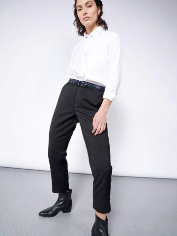 White long-sleeve button up with black trousers