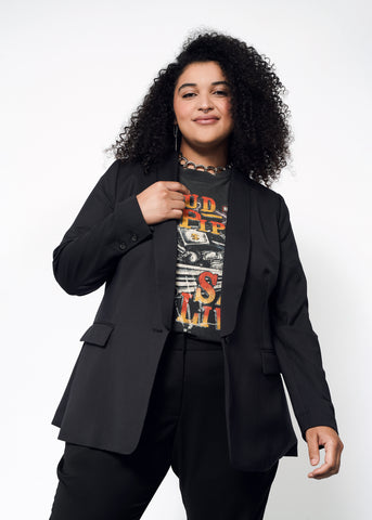 Black blazer layered on top of a graphic tee shirt