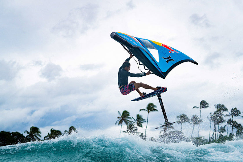 Red Bull Team rider, Kai Lenny getting air while wing foiling in the tropics