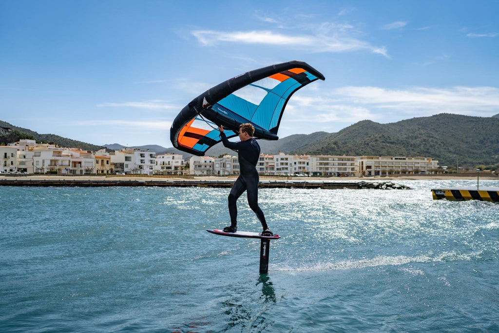 Kevin Langeree wing foiling in the bay wearing his O'Neill Hyperfreak Wetsuit. 