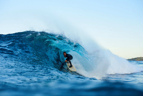 Man surfing a barrel in a O'Neill Wetsuit