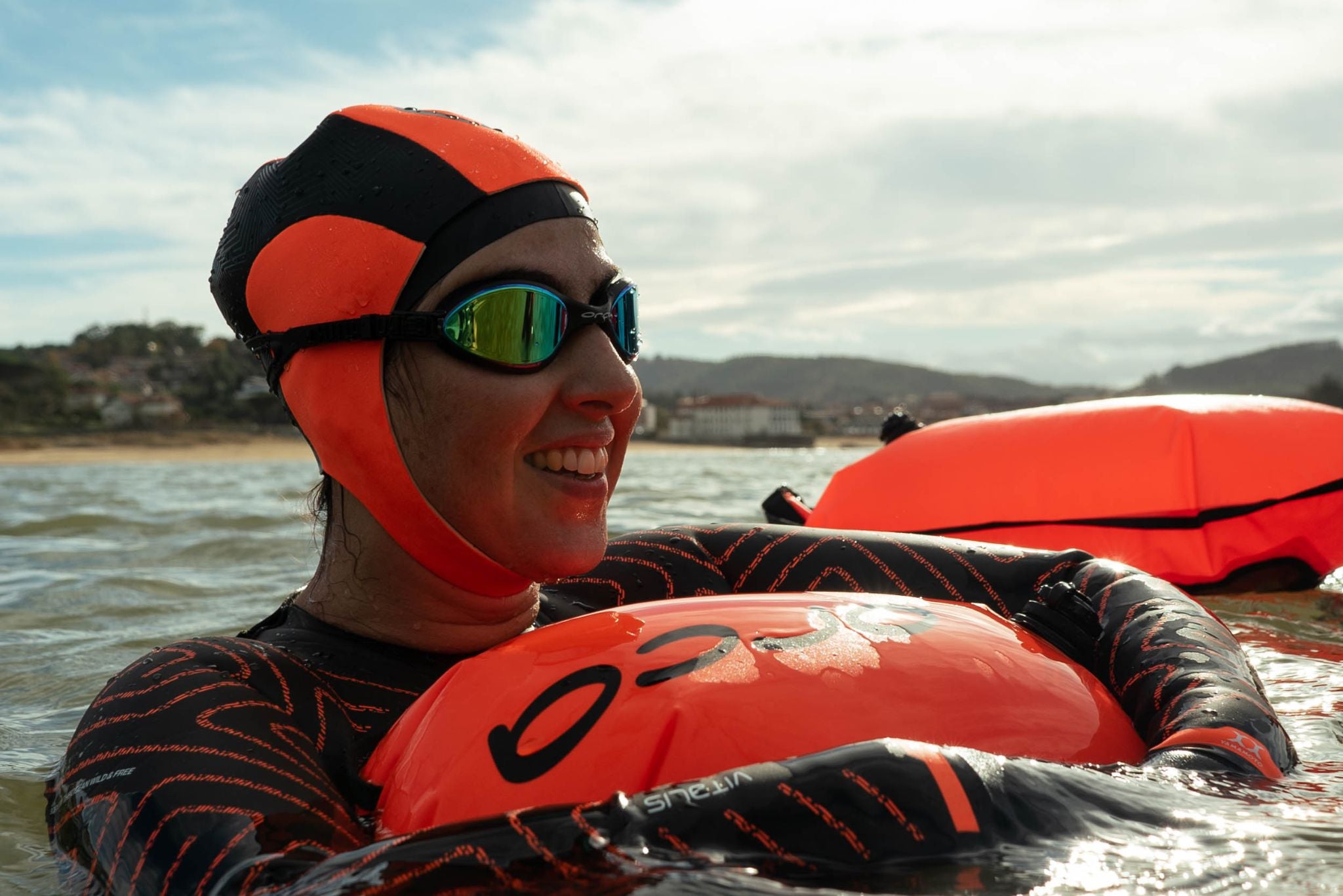 Woman holding a swimming tow float in the water