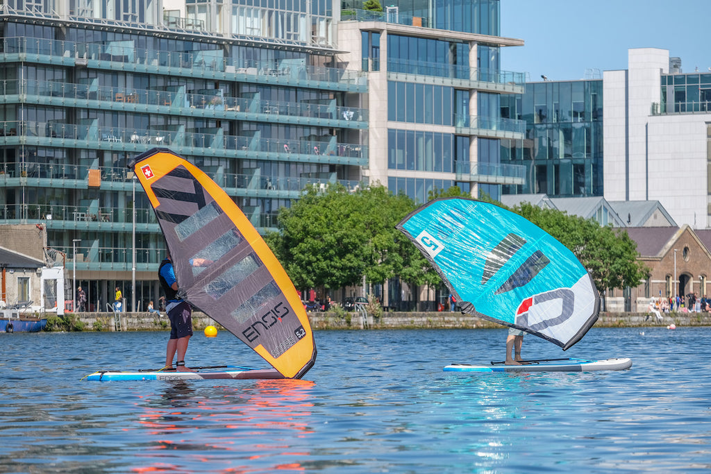 A couple of people learning to wingsurf at Surfdock in grand canal dock Dublin. 