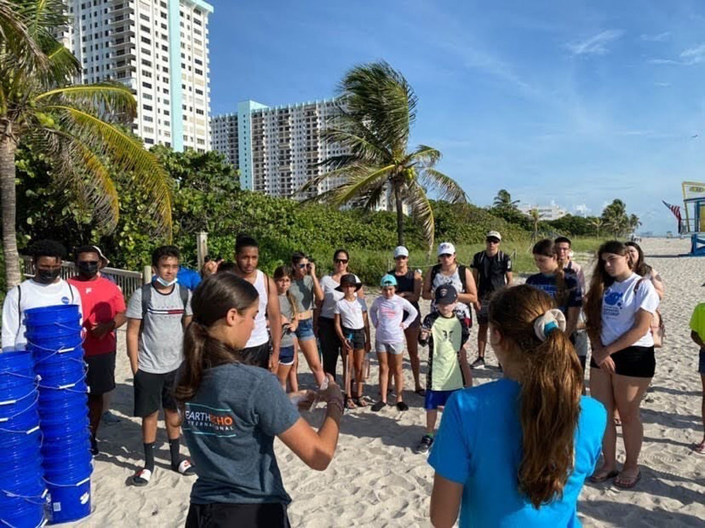 Emilia Fiebel leading a beach cleanup