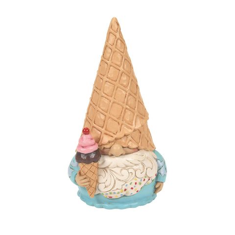 This Jim Shore ice cream gnome eats an ice cream cone and sports a sprinkle beard and waffle hat.