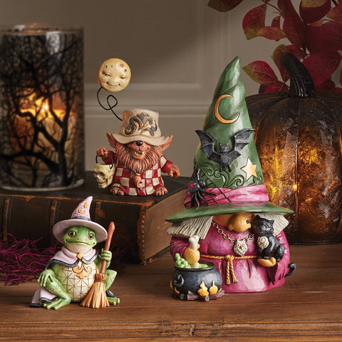 This Jim Shore gnome is a spooky sight! With a black cat, cauldron, and warty nose, this wicked witch brews trouble. Her green hat is decorated with a star, moon, bat, and black widow spider. Beware the boiling green bubbles and skull and bones!