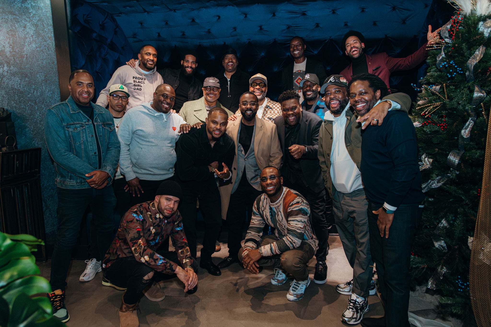 A group of Black men smiling and hugging at the Knights Table dinner in Atlanta