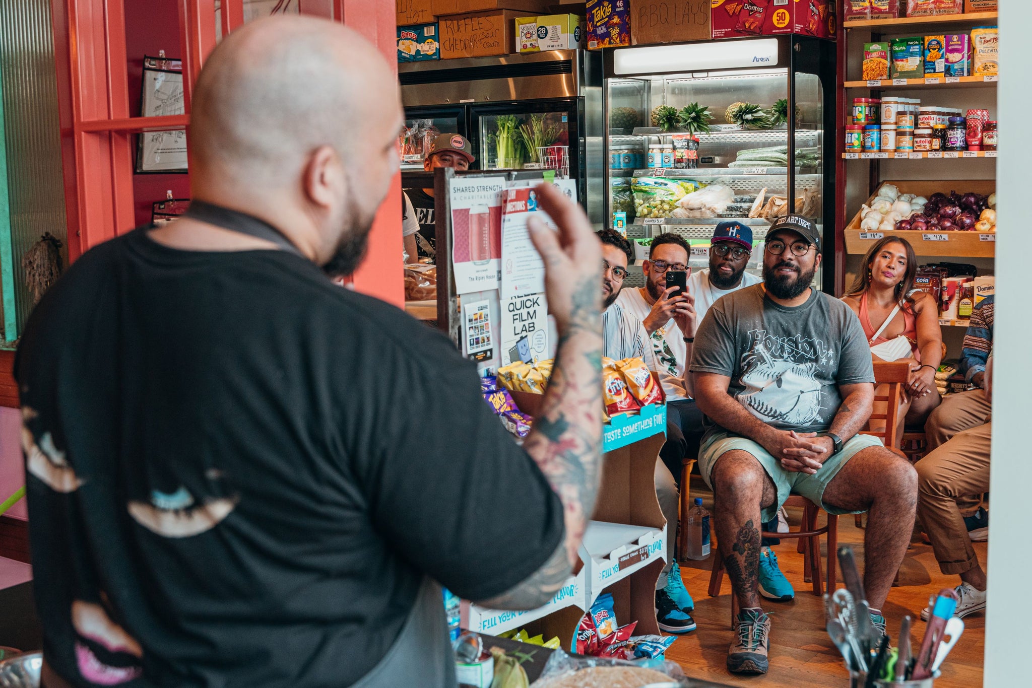 Chef Nieves presents to a small audience inside a grocery store