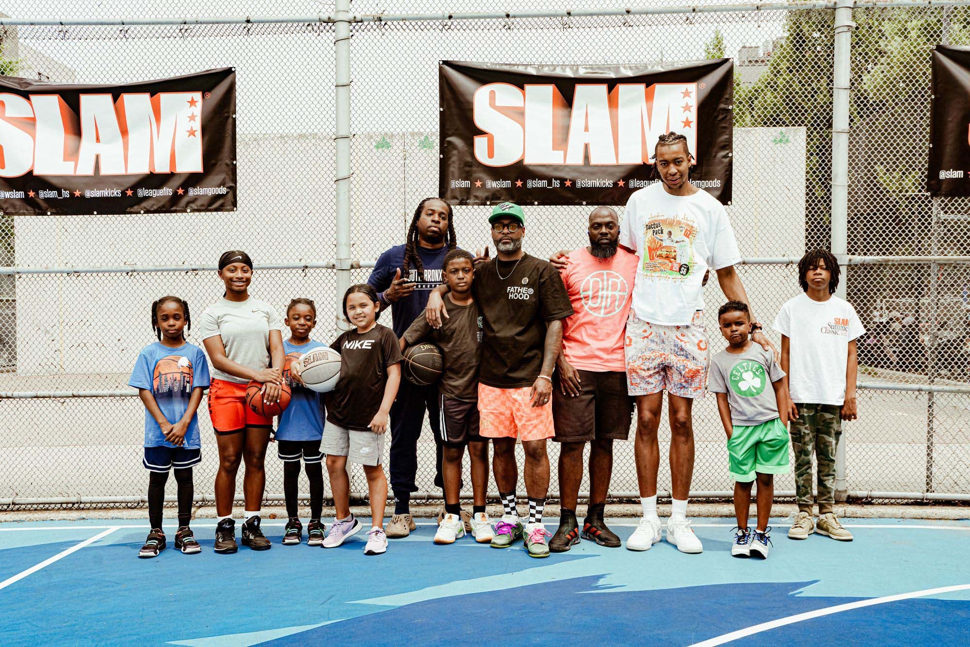 A group shot of the dads and their kids on the court