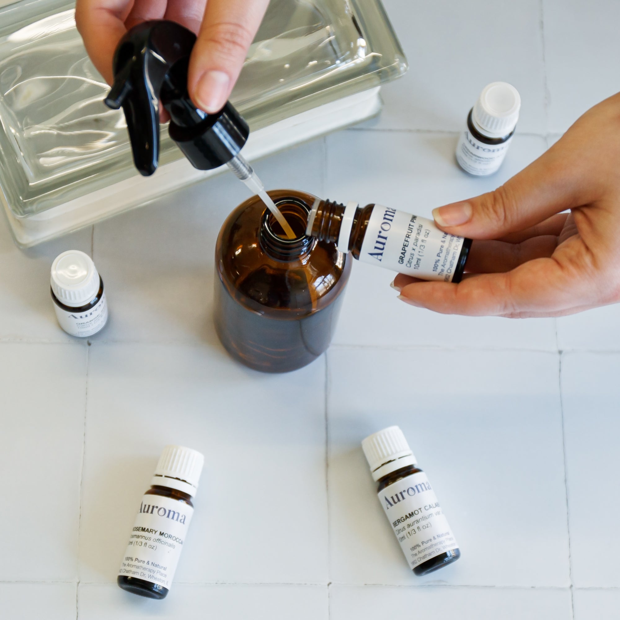 Auroma essential oils being poured into amber bottle