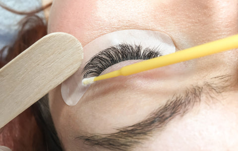 A woman getting her eyelash extensions re-done. 