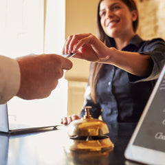 Hotel receptionist handing over keycard