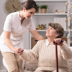 Care home worker assisting patient