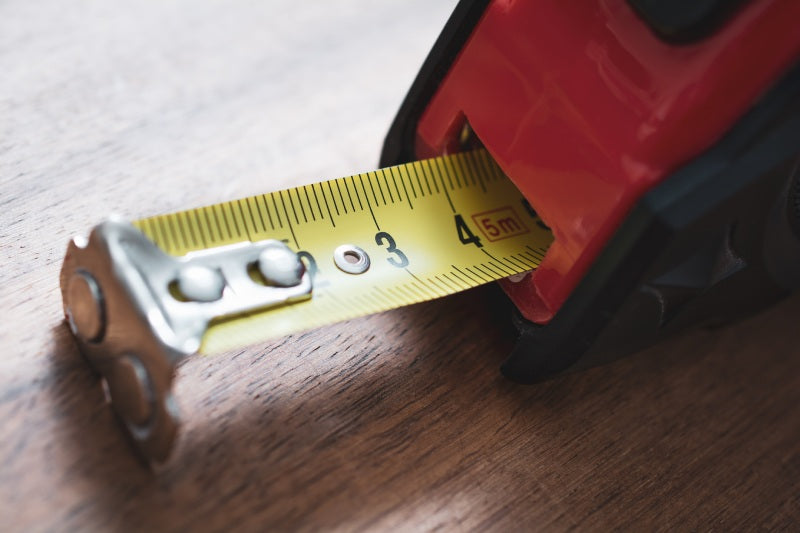 Tape measure to measure the room before installing solid wood flooring