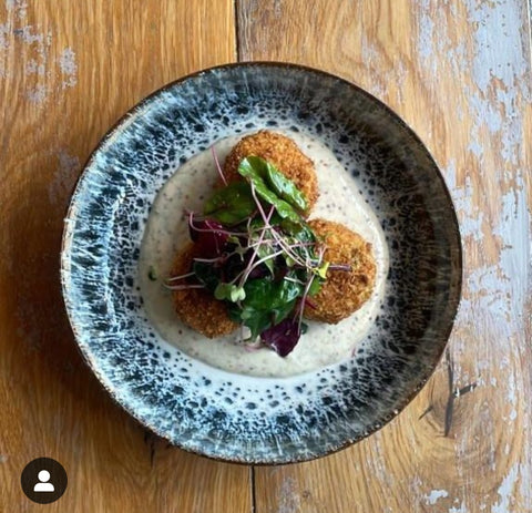 Fresh haddock and dill croquettes with Velvet Cloud, stout and treacle mustard, Topped with microgreens radish and lightly dressed mixed leaves – By Hooked Sligo