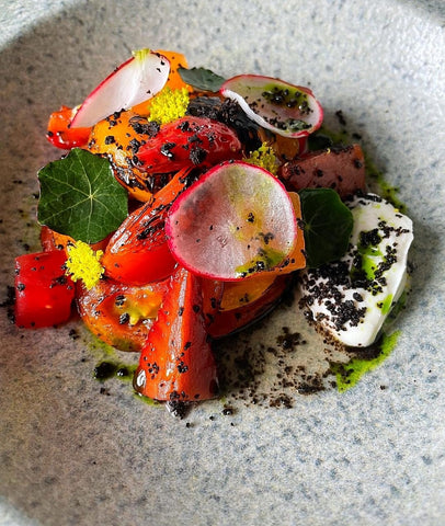 Heritage tomatoes and Velvet Cloud labneh, compressed melon, balsamic strawberry, fermented honey, olive, nasturtium