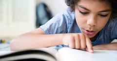 Child using productive struggle to learn to read.