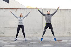 Couple doing jumping jacks