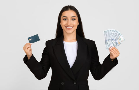 A confident businesswoman holding a credit card and cash, symbolizing the secure payment choices