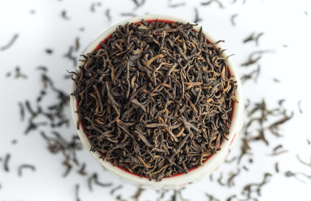 tasse remplie de feuilles de thé en vrac bio